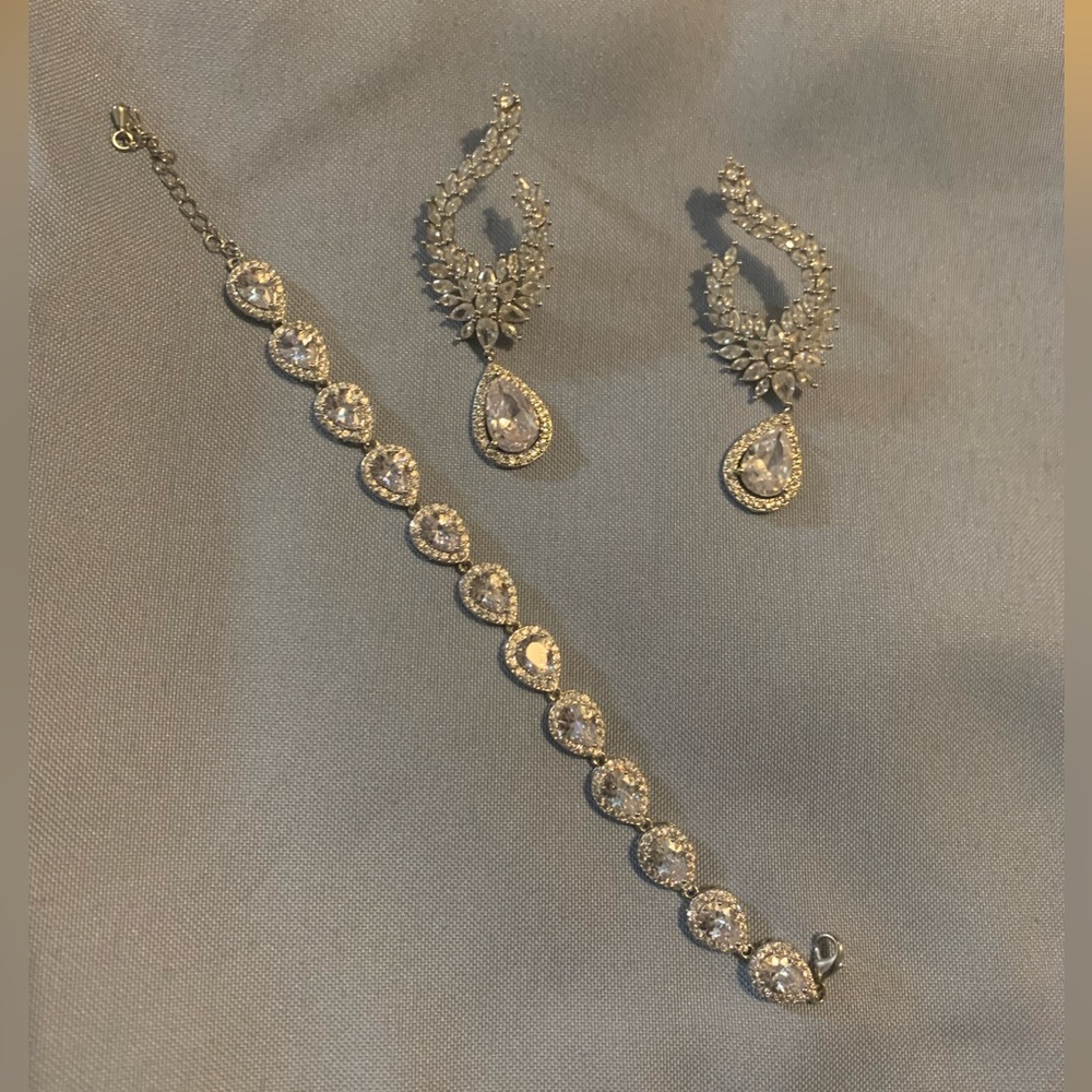 Silver and clear stone earring and  bracelet set. Costume jewelry. Not real.